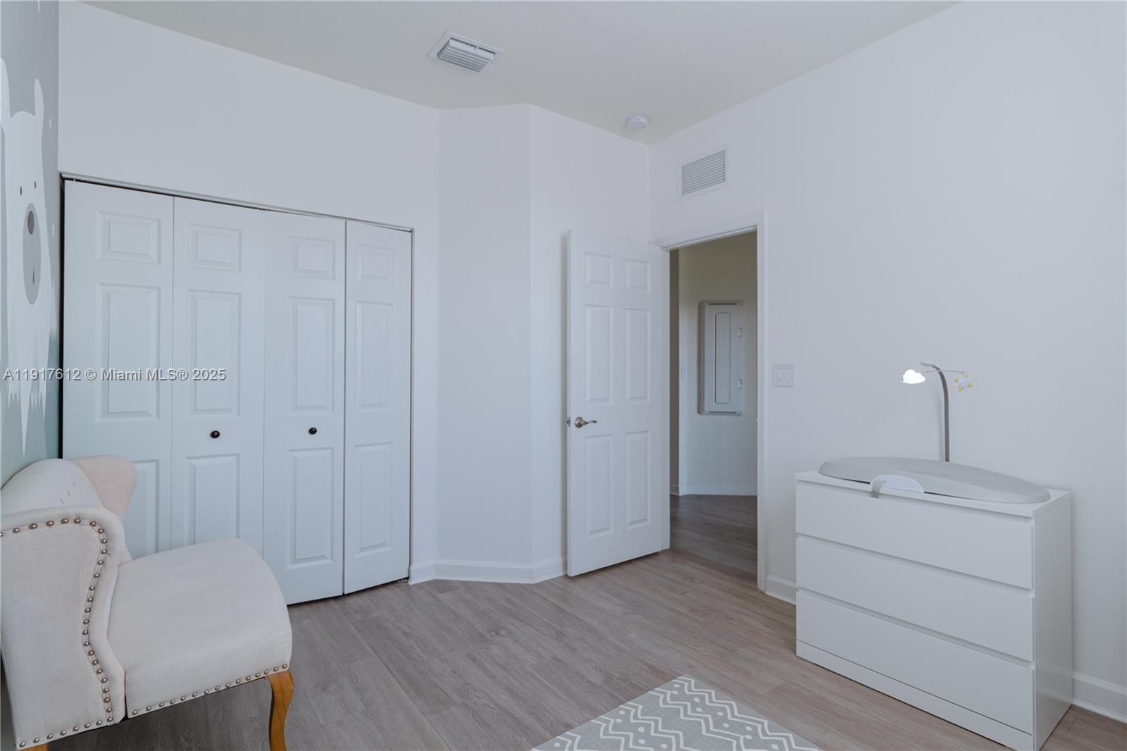 3435 West 105th Street Hialeah, FL 33018 - Photo 20 of 41 a view of a room with wooden floor and closet