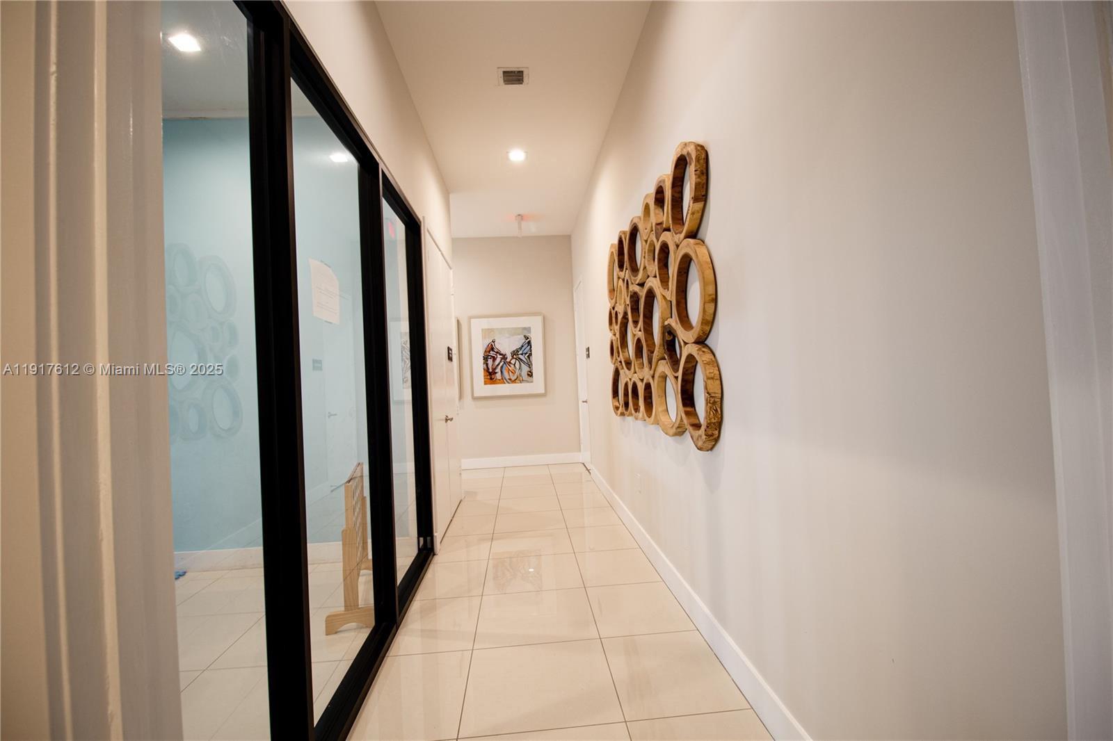 3435 West 105th Street Hialeah, FL 33018 - Photo 37 of 41 a view of a hallway with wooden floor