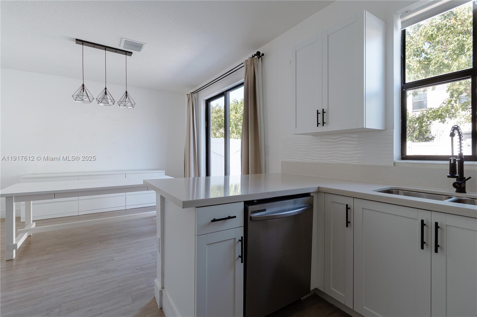3435 West 105th Street Hialeah, FL 33018 - Photo 10 of 41 a kitchen with a sink and cabinets