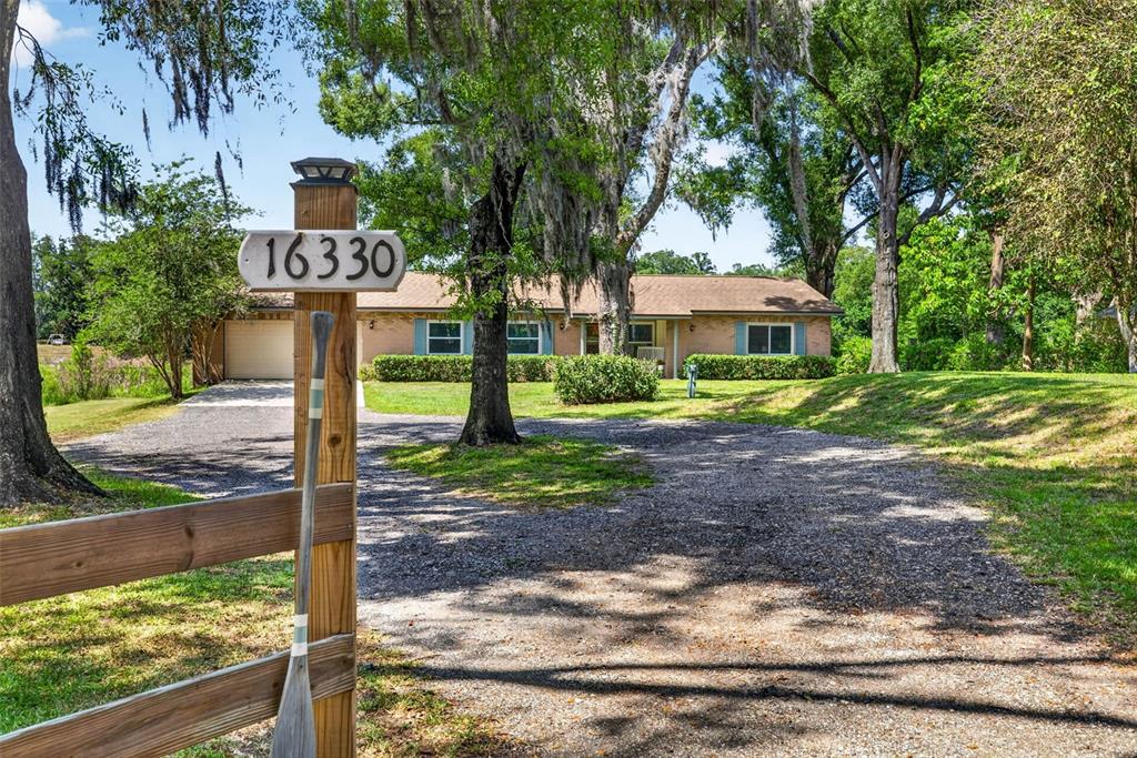 16330 Hanna Road Lutz, FL 33549 - Photo 4 of 41 a front view of a house with a yard