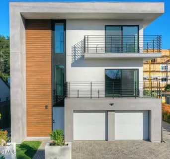 an empty room with wooden floor & windows