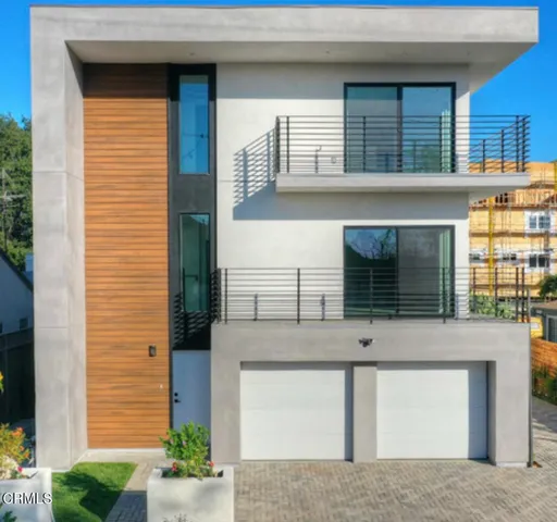 an empty room with wooden floor & windows