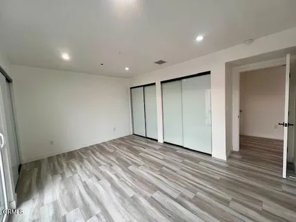 a view of staircase with lots of frames on wall and a window