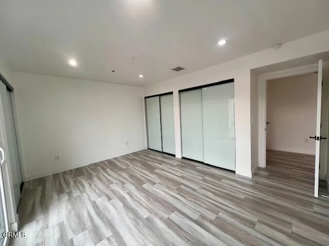 a view of staircase with lots of frames on wall and a window