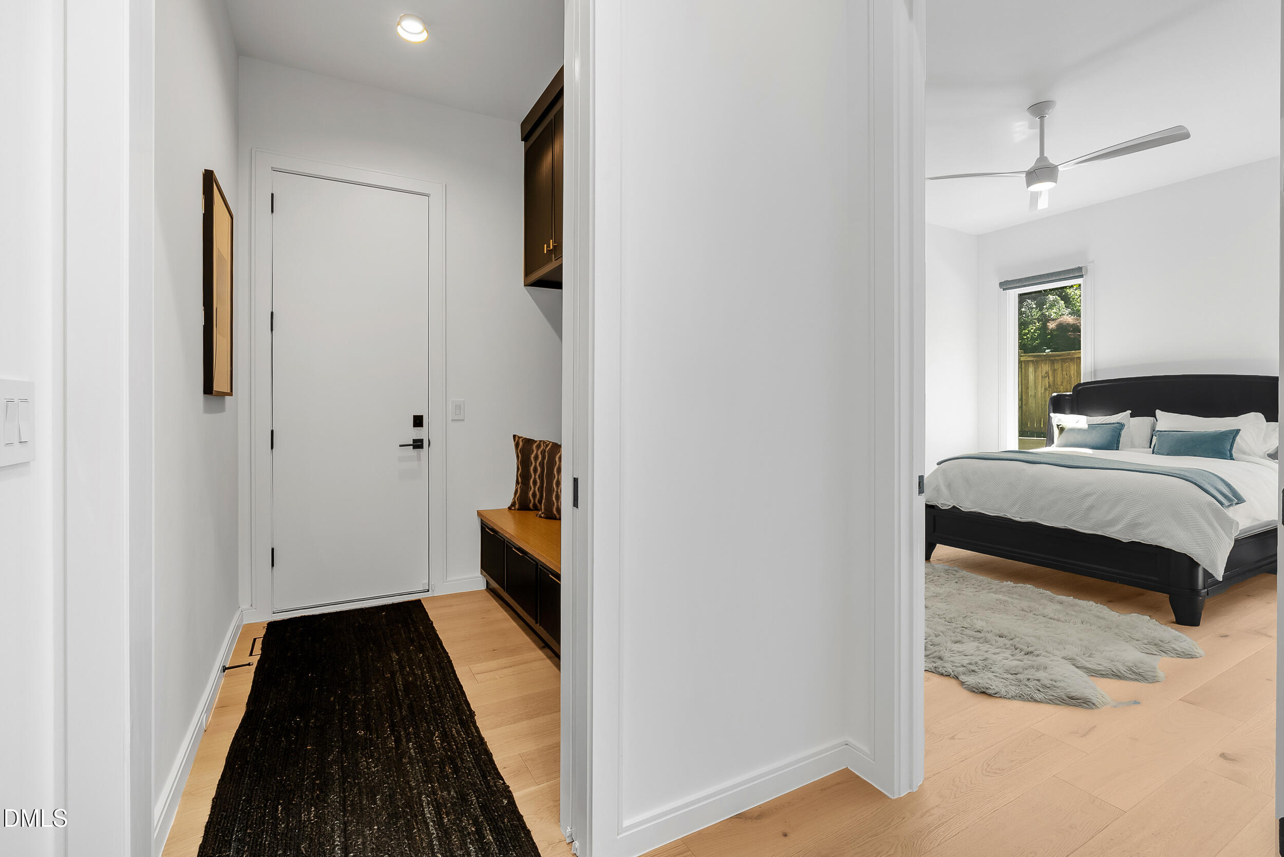 2105 Manuel Street Raleigh, NC 27612 - Photo 24 of 63 a bedroom with a bed and a walk in closet with wooden floor