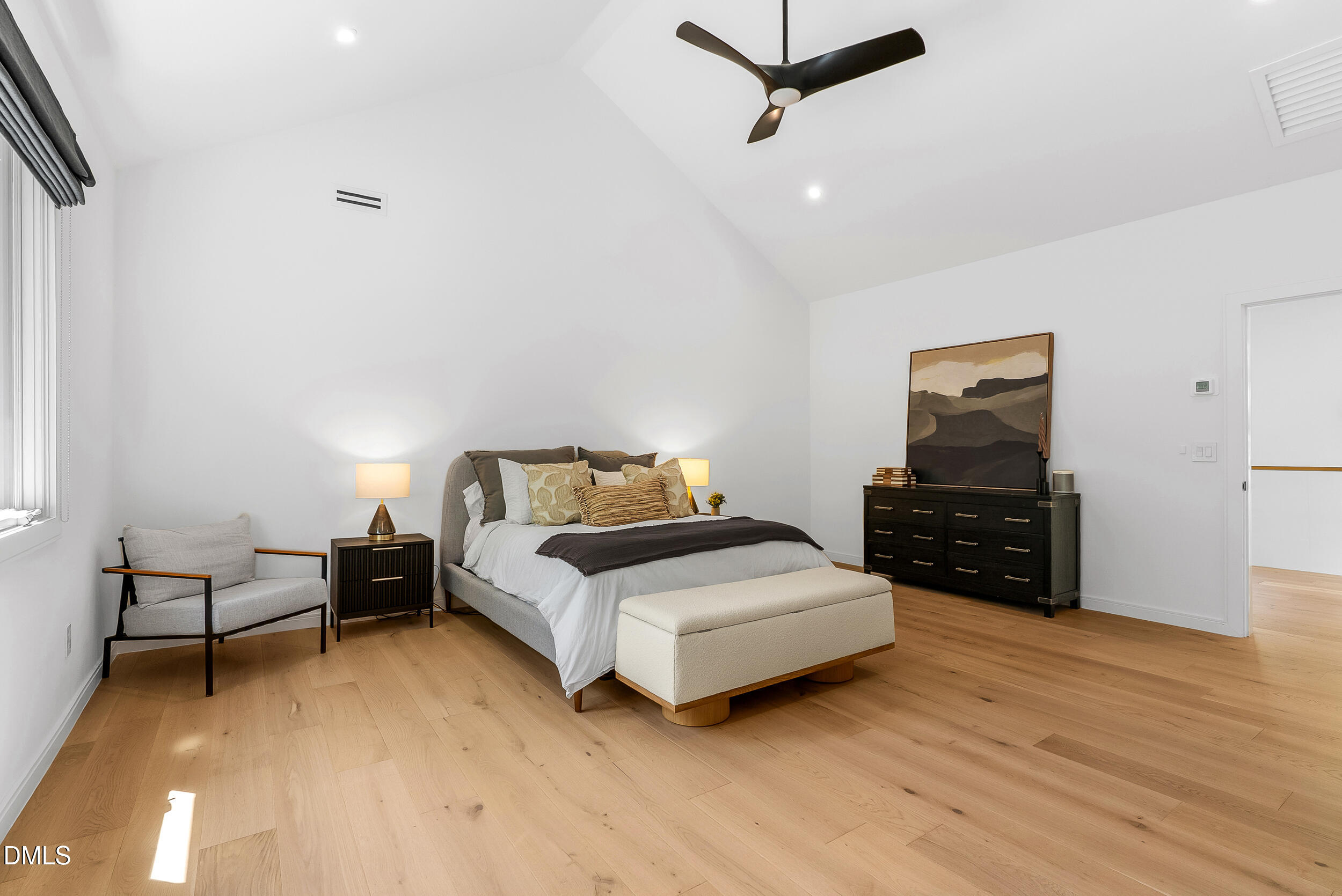 2105 Manuel Street Raleigh, NC 27612 - Photo 32 of 63 a spacious bedroom with a bed and a flat screen tv