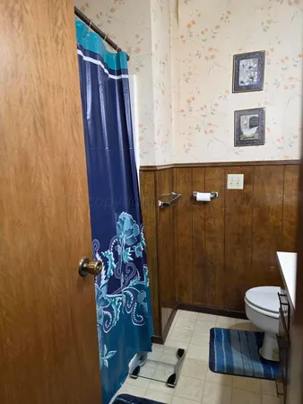 a bathroom with a toilet and a shower