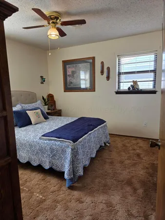 a bedroom with bed and window