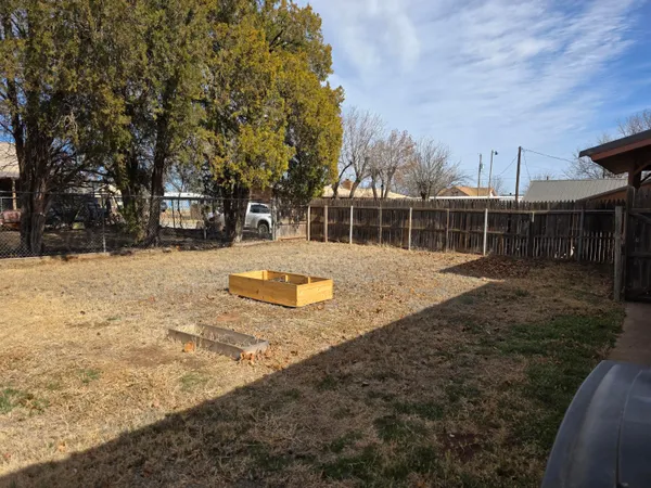 a view of yard with swimming pool and trees