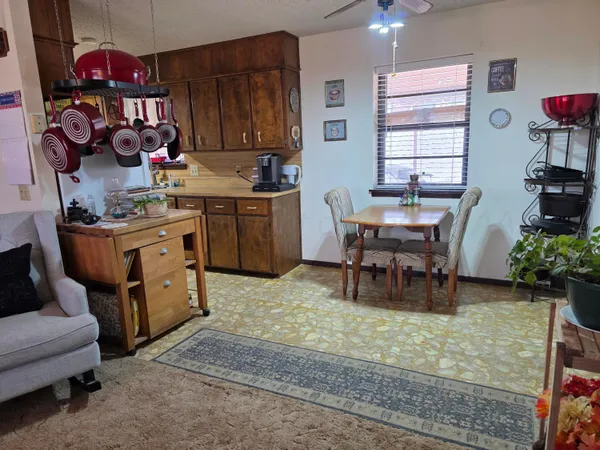a kitchen with a cabinets and chairs in it