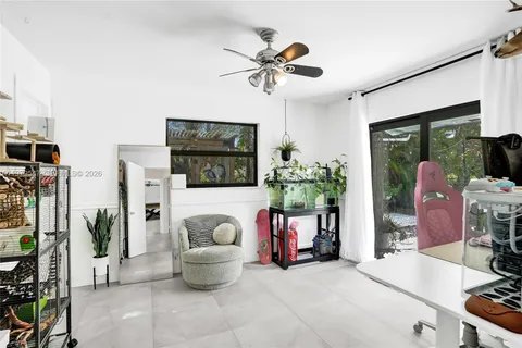 a living room with furniture and flowers