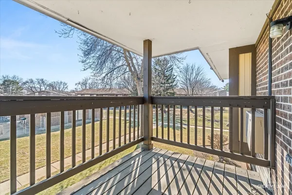 a view of a balcony with wooden floor