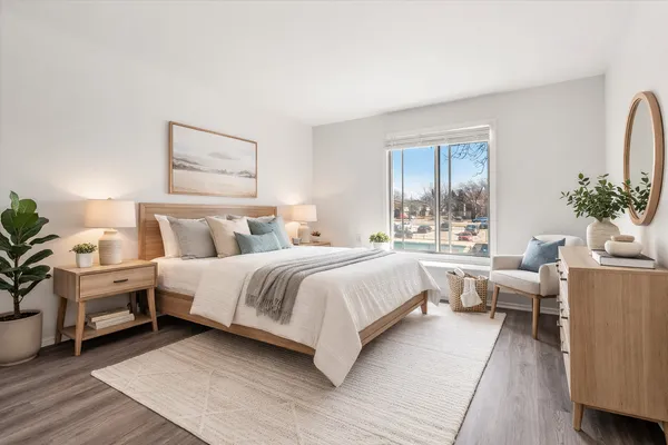 a bedroom with bed and a potted plant