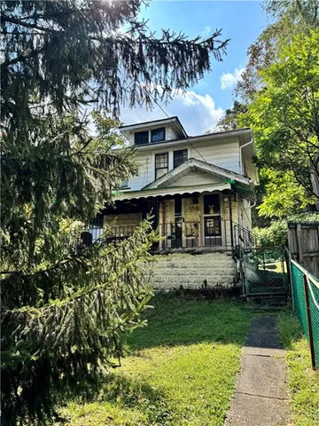 a front view of a house with a yard table and chairs