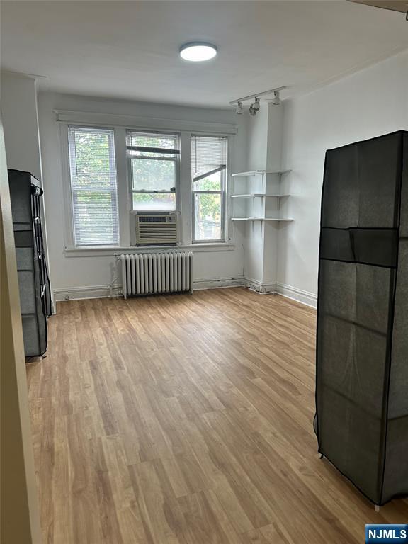 141 67th Street, Unit 2 West New York, NJ 07093 - Photo 2 of 12 a view of an empty room with a window and wooden floor