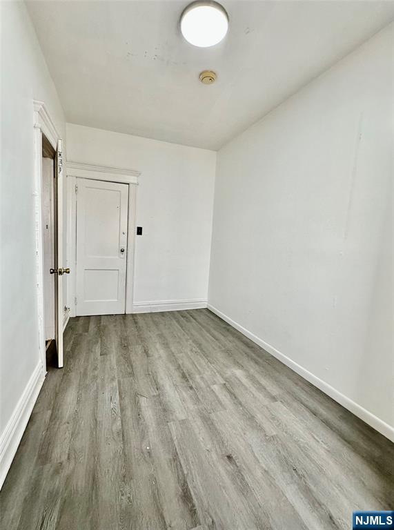 141 67th Street, Unit 2 West New York, NJ 07093 - Photo 5 of 12 a view of a room with wooden floor and white walls