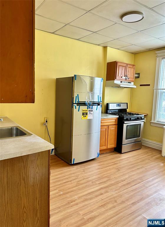 141 67th Street, Unit 2 West New York, NJ 07093 - Photo 7 of 12 a kitchen with stainless steel appliances granite countertop a refrigerator a stove and a wooden floors