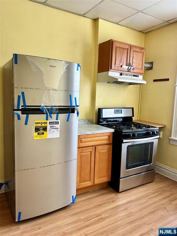 141 67th Street, Unit 2 West New York, NJ 07093 - Photo 8 of 12 a utility room with stainless steel appliances and wooden floor