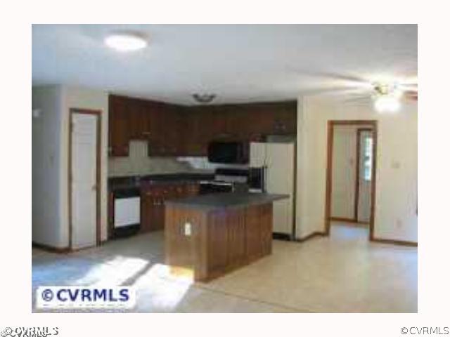 4828 Bradshaw Road Gum Spring, VA 23065 - Photo 5 of 10 a kitchen view with cabinets and refrigerator