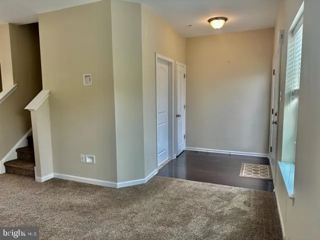 an empty room with wooden floor and closet