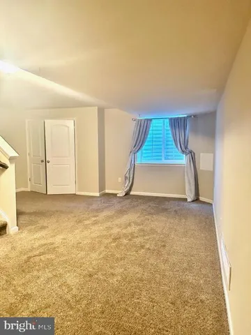 an empty room with wooden floor and closet