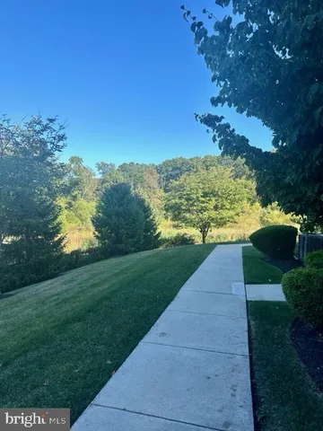 a view of a pathway with a garden