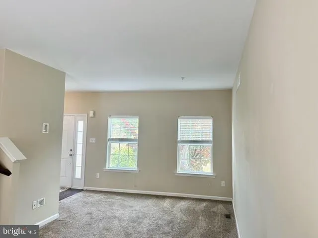 a view of a big room with closet and windows