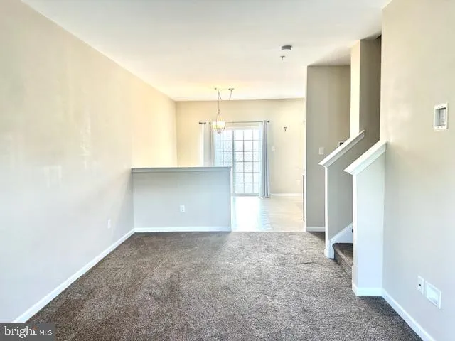 a kitchen with stainless steel appliances kitchen island granite countertop a refrigerator stove and sink