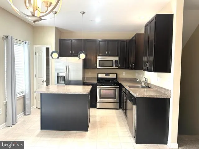 a view of a kitchen cabinets and a chandelier