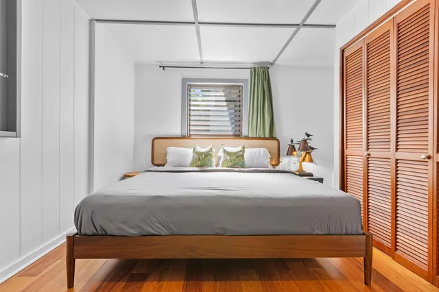 a bedroom with a bed and window