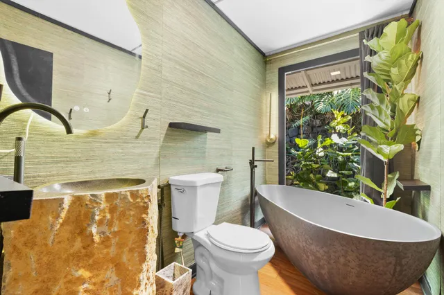 a white toilet sitting next to a shower curtain