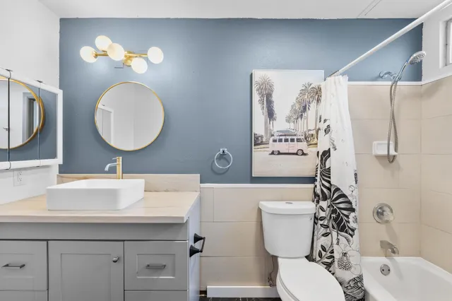 a bathroom with a toilet a sink and a mirror