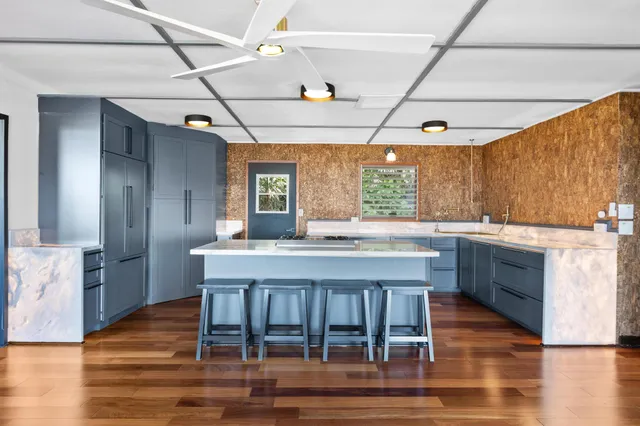 a kitchen with granite countertop a counter space a sink appliances and cabinets