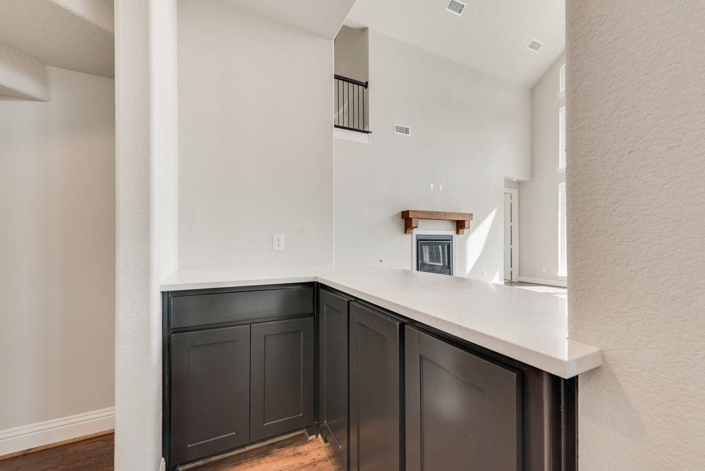 1231 Calebria Way Fate, TX 75087 - Photo 17 of 40 a kitchen with a sink and cabinets