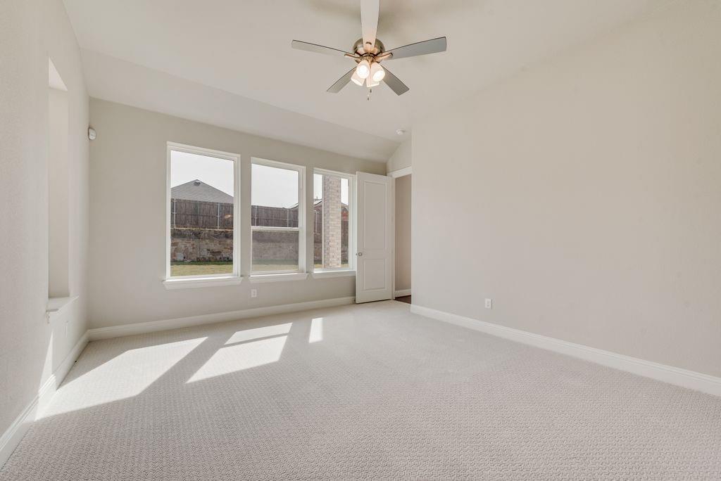 1231 Calebria Way Fate, TX 75087 - Photo 18 of 40 an empty room with windows and fan
