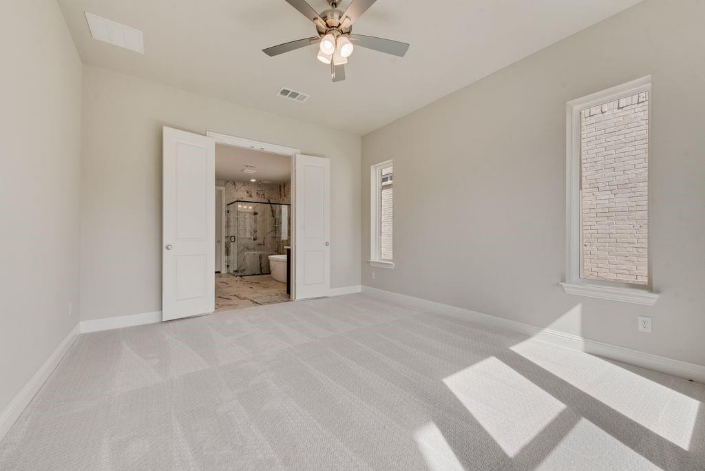 1231 Calebria Way Fate, TX 75087 - Photo 19 of 40 a view of an empty room with a bathroom