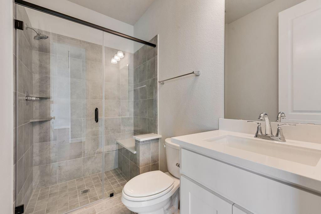 1231 Calebria Way Fate, TX 75087 - Photo 25 of 40 a bathroom with a sink a toilet and shower