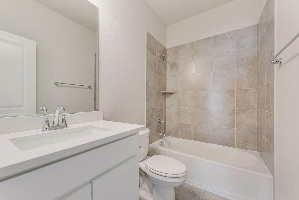 1231 Calebria Way Fate, TX 75087 - Photo 33 of 40 a bathroom with a sink toilet and shower