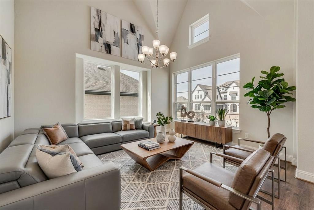 1231 Calebria Way Fate, TX 75087 - Photo 6 of 40 a living room with furniture a chandelier and a window