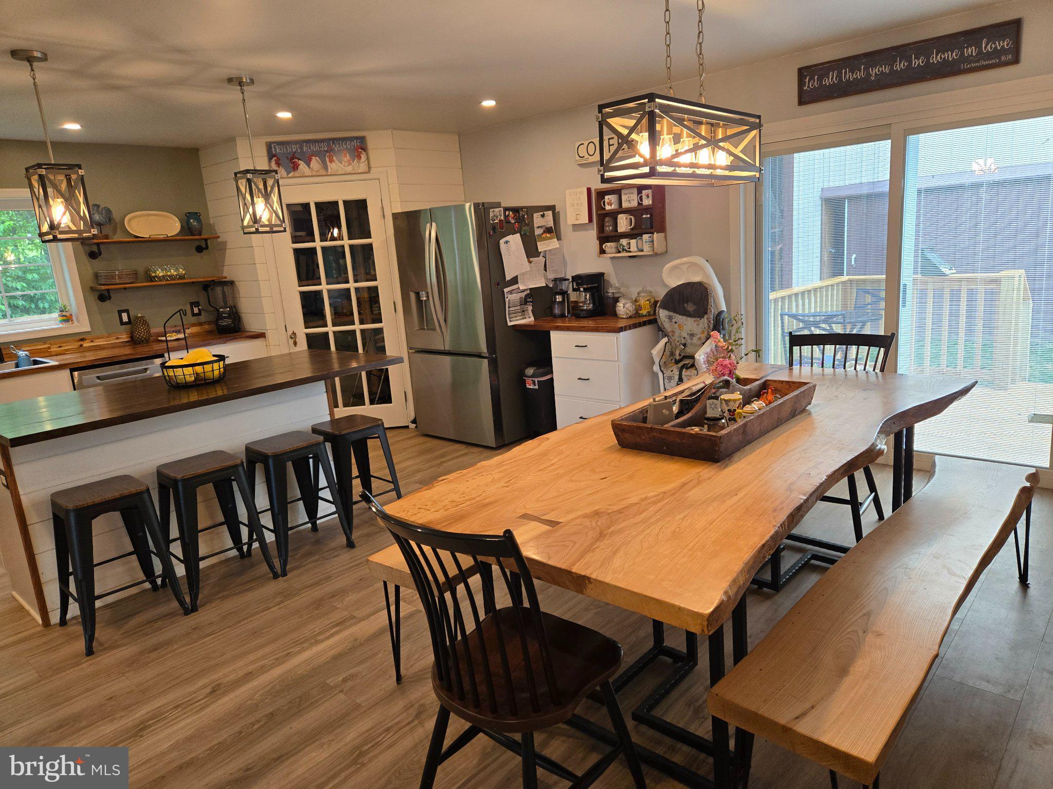 1669 Colebrook Road Lebanon, PA 17042 - Photo 13 of 34 a kitchen with stainless steel appliances granite countertop a stove a refrigerator a dining table and chairs with wooden floor
