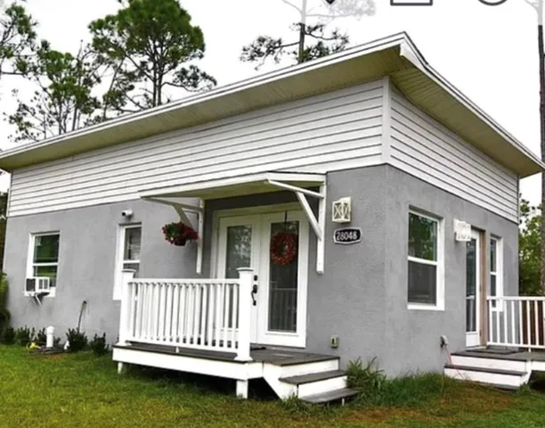 a view of a house with a small deck