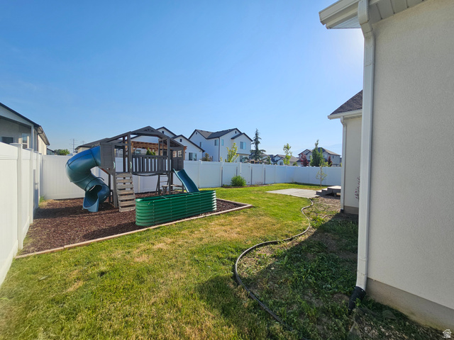 2508 Sunset Way Layton, UT 84041 - Photo 17 of 35 Spacious backyard featuring a manicured lawn, white vinyl fencing, and a concrete patio