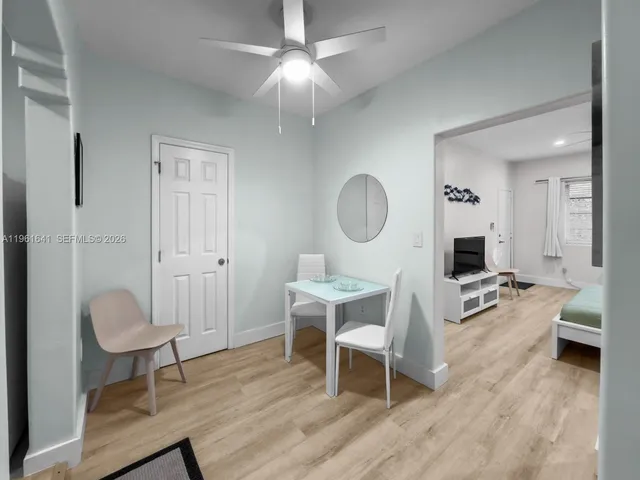 a living room with furniture a mirror and a table