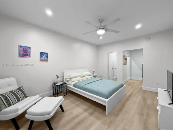 a bedroom with a bed and a chandelier