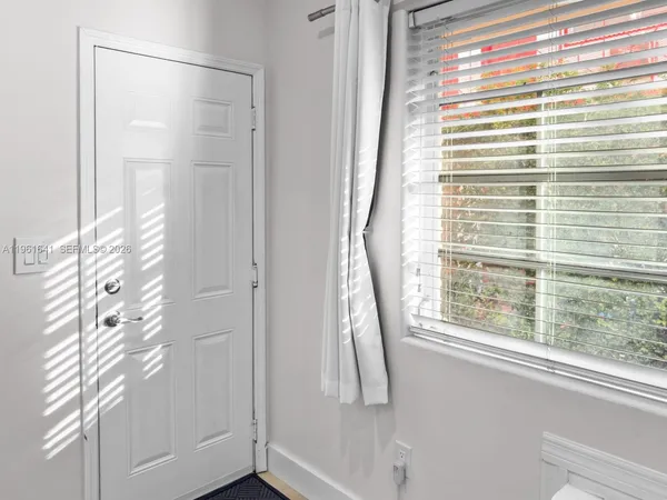 a view of a bathroom with a shower and a window