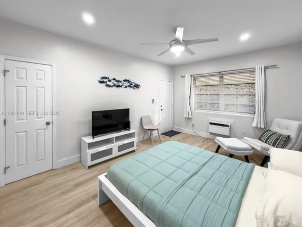 a bedroom with a bed and a flat screen tv