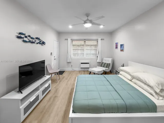 a bedroom with a bed and a television