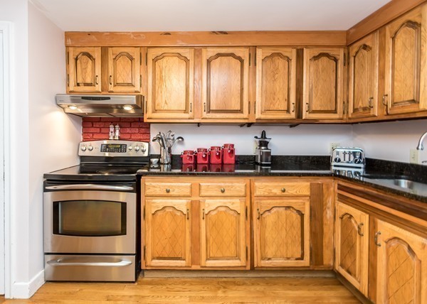 1131 Trapelo Road Waltham, MA 02451 - Photo 8 of 23 a kitchen with stainless steel appliances granite countertop a refrigerator and stove top oven