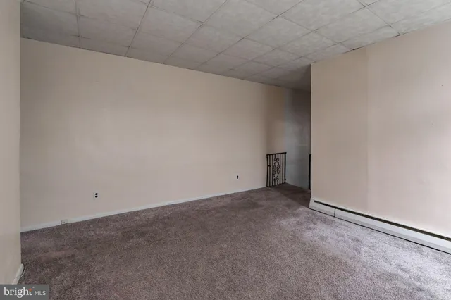 a view of an empty room and a fireplace