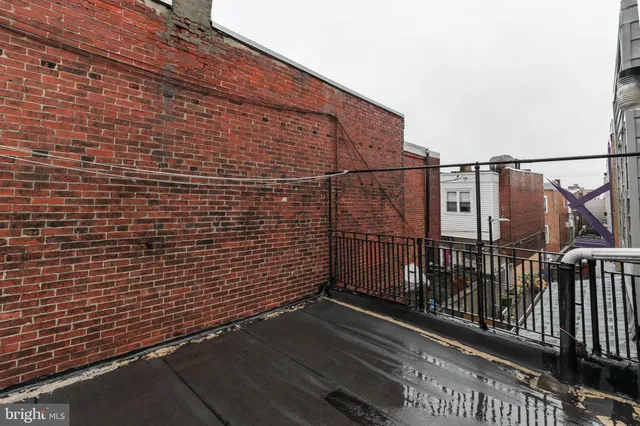 a view of a brick house with many windows